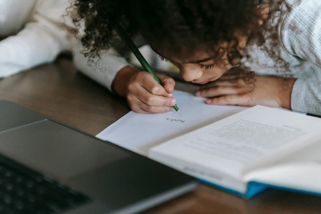 Young student receiving dyslexia writing support while homeschooling